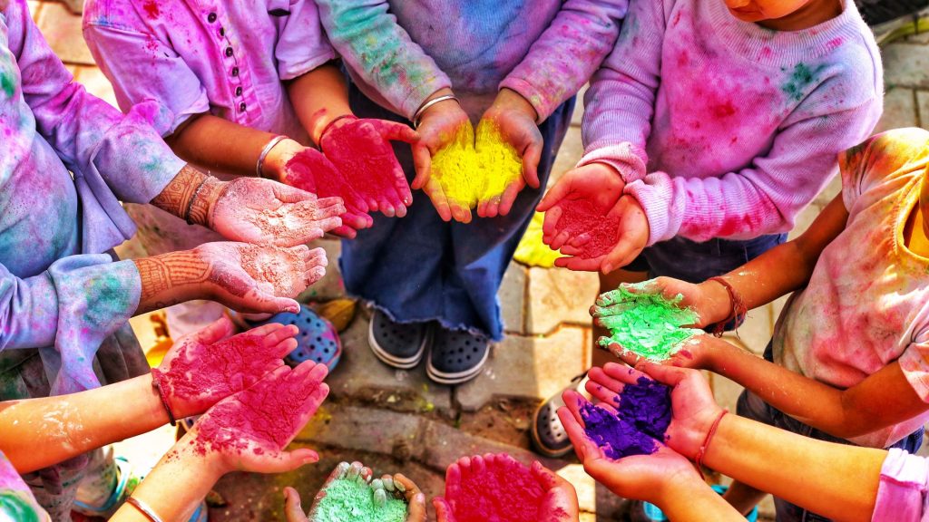Kids celebrating Holi using colors